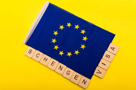 European union concept showing the flag of the EU on a yellow background with a sign reading Schengen Visaの写真素材