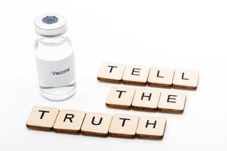 Vaccine concept showing a medical vial with a Vaccine label on a white background along with a sign...