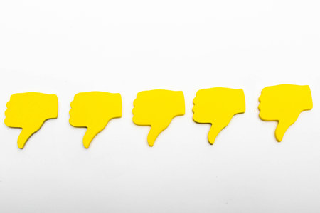 Customer feedback concept showing five yellow hands isolated on a plain background showing five...