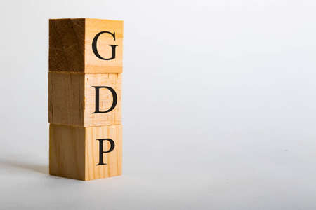 Wooden cubes with lettering spelling GDP. Business or political conceptの写真素材