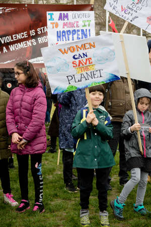 London, United Kingdom, March 8th 2020:- People take part in the March For Women hosted by Care International rally in Parliament Squareのeditorial素材