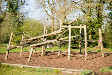 Sandhurst, United Kingdom, 9th April 2020:- Taped off children's play equipment in a closed play...