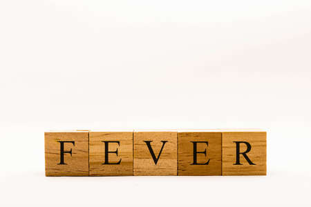 Coronavirus concept showing wooden blocks on a white background reading Feverの写真素材