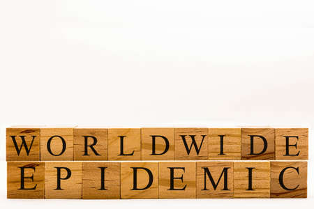 Coronavirus concept showing wooden blocks on a white background reading Worldwide Epidemicの写真素材