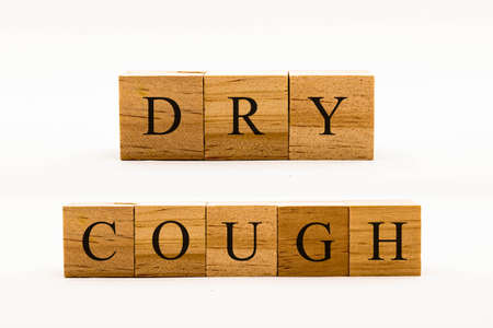 Coronavirus concept showing wooden blocks on a white background reading Dry Coughの写真素材