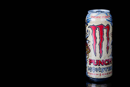 London, United Kingdom, 14th October 2020:- A can of Monster Pacific Punch Energy Drink Isolated on a black backgroundのeditorial素材