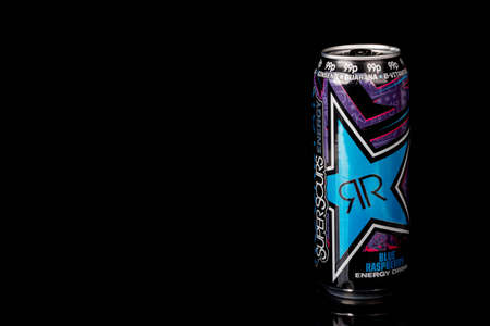 London, United Kingdom, 14th October 2020:- A can of Rockstar Blue Raspberry Energy Drink Isolated on a black backgroundのeditorial素材