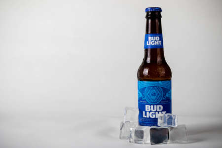 Sandhurst, United Kingdom; February 13th 2021:- A cold bottle of Bud light with ice cubes, isolated on a white backgroundのeditorial素材