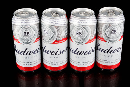 Sandhurst, United Kingdom; February 13th 2021:- Four cans of Budweiser isolated on a black backgroundのeditorial素材