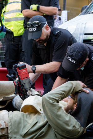 London, United Kingdom, 21st August 2021:- Specialist police officers use cutting equipment to...