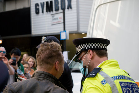 London, United Kingdom, 21st August 2021:- An Extinction Rebellion protester is arrested after being removed from under a van in central Londonのeditorial素材