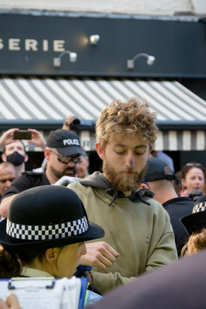 London, United Kingdom, 21st August 2021:- An Extinction Rebellion protester is arrested after being removed from under a van in central Londonのeditorial素材
