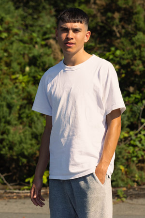 18 year old teen boy in a white t-shirt outdoors