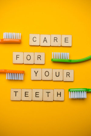 Oral and dental health concept showing four toothbrushes and a sign reading Care For Your Teeth on a...