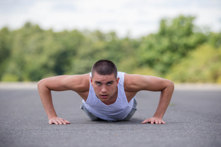 A Nineteen Year Old Teenage Boy Doing Push Ups A Public Park