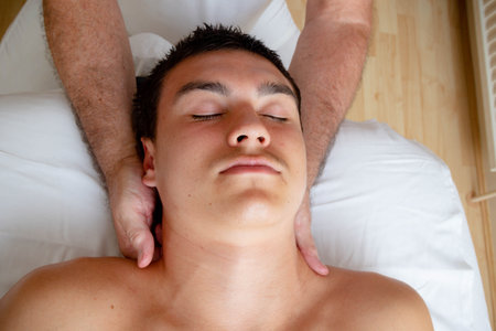 A Nineteen Year Old Teenage Boy Having A Head and Neck MAssageの写真素材
