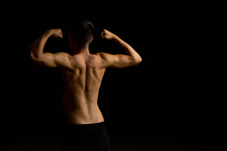 19 year old teenage boy doing situps on an excercise bench in a tank top