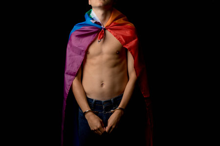 A Shirtless 19 Year Old Teenage Boy wrapped in A Pride Flag Under Arrestの写真素材