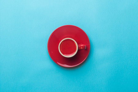 An Espresso coffee cup and saucer on a blue backgroundの写真素材