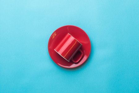 An Espresso coffee cup and saucer on a blue backgroundの写真素材