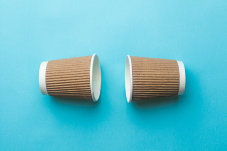2 Empty coffee cups on a blue backgroundの写真素材
