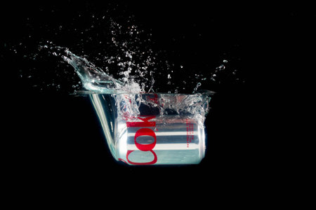 London, United Kingdom, 24th July 2023: A Can of Diet Coke splashing into water against a black backgroundのeditorial素材