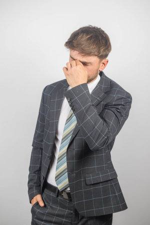 Portrait of a young entrepreneur in a suit and tie stressingの写真素材