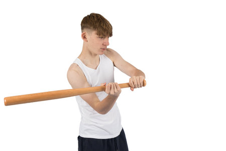A caucasian teeanage boy holding baseball bat about to swing