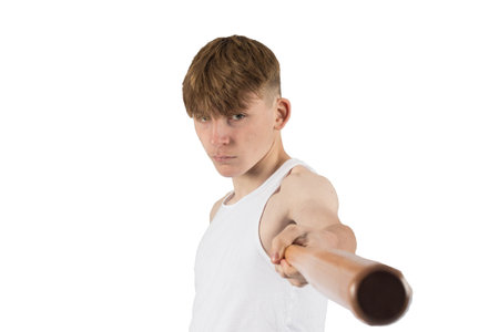 A caucasian teeanage boy holding baseball bat in a threatening way