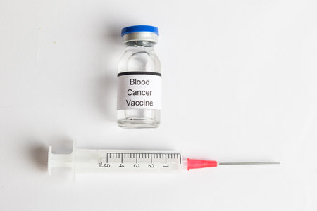 A Medical Vial with a label reading Blood Cancer Vaccine with a Syringeの写真素材