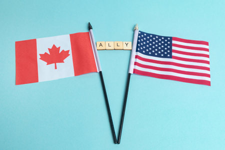 The Flags of The United States and Canada trade war concept, with tiles reading Allyの写真素材