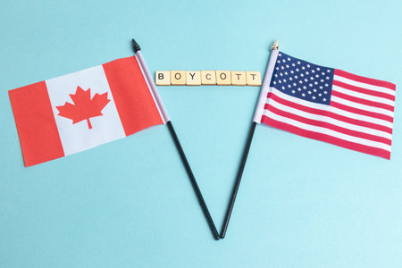 The Flags of The United States and Canada trade war concept, with tiles reading Boycottの写真素材