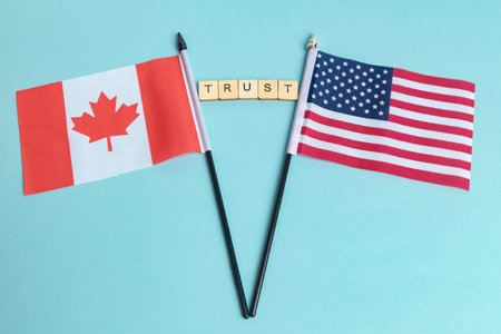 The Flags of The United States and Canada trade war concept, with tiles reading Trust