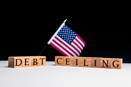 United States of America Concept, with selective focus on the US flag along with a sign reading Debt...