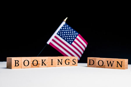 United States of America Concept, with selective focus on the US flag along with a sign reading Bookings Downの写真素材