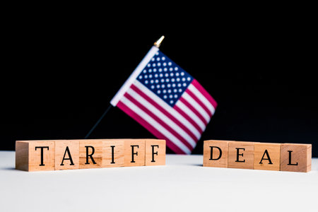 United States of America Concept, with selective focus on the US flag along with a sign reading Tariff Dealの写真素材