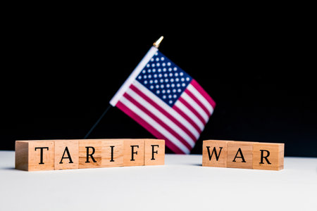 United States of America Concept, with selective focus on the US flag along with a sign reading Tariff Warの写真素材