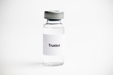 Vaccine concept, a medical vial with a label reading on a plain white background.の写真素材
