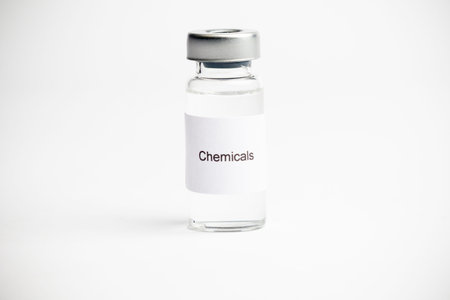 A medical vial with a label reading Chemicals on a plain white background.の写真素材