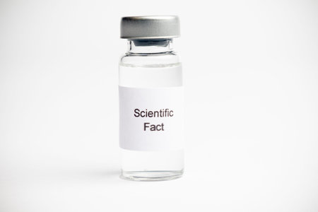 Vaccine concept, a medical vial with a label reading on a plain white background.