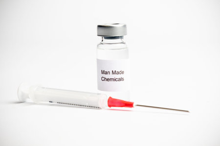 Vaccine concept, a medical vial with a label reading and a syringe on a plain white background.