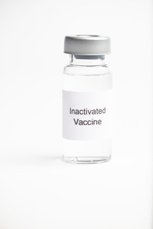Vaccine concept, an isolated medical vial with a label reading  Inactive Vaccine  on a plain white...