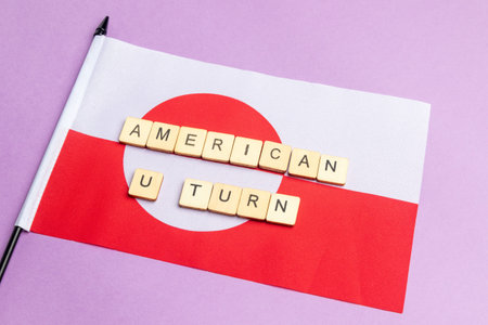 The Flag of Greenland Against A Purple Background With The Sign Reading U Turnの写真素材