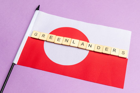 The Flag of Greenland Against A Purple Background With The Sign Reading Greenlandersの写真素材