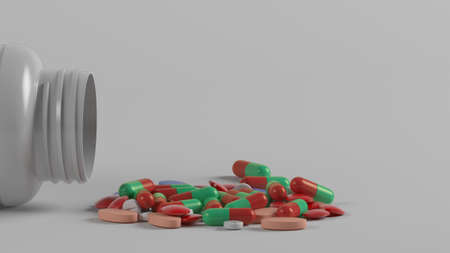 White medicine bottle and colorful medicinesの写真素材