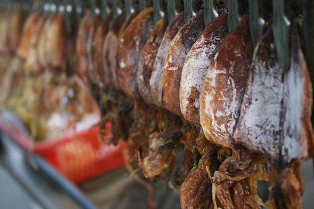 A snack stall selling squid found in Thailand.の写真素材