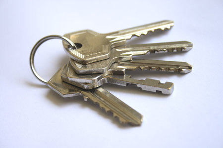 Bunch of keys on a white paper as background.