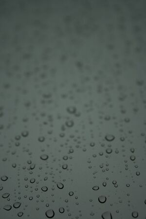 Raindrops on glass can be use as background in design.の写真素材