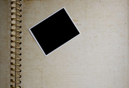 Background made from an open old grunge album with photo on it.の写真素材