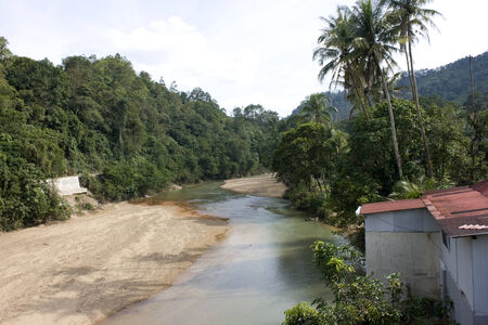 River pass by a village in Malaysia の写真素材